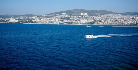 Aerial view of a sailboat drifting peacefully on a tranquil body of water in Kusadasi, Turkey