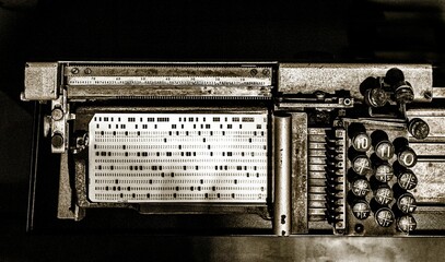 Grayscale shot of an old punch card machine