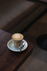 latte art on te wood table in the coffee shop
