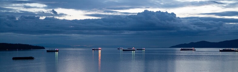 Panoramic shot of freighters in English Bay in the evening.