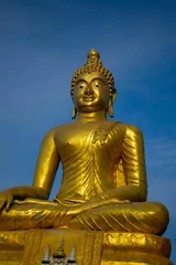 Zelfklevend Fotobehang Historisch monument Golden Buddha statue against a blue sky.