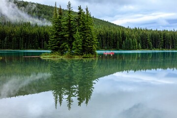 Couple rowing a boat on Two Jack Lake in Alberta, Canada