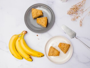 Top view of the slices of freshly baked banana cake on a marble table