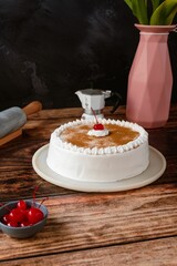 Delicious tres leches cake on a wooden table