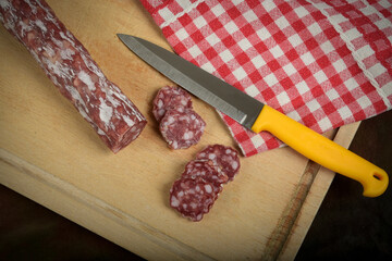 view of dry sausage on cutting board