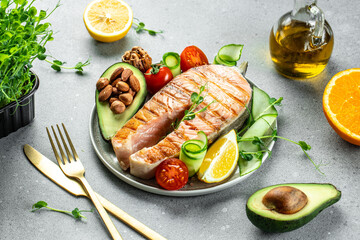 Salmon fish steak grilled, avocado and fresh vegetable salad. Ketogenic diet. Low carb high fat breakfast. Healthy food concept. place for text, top view