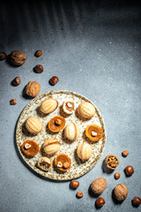 Homemade nuts cookies filled with boiled condensed milk cream on a light background. vertical image. top view. place for text