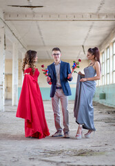 Fototapeta na wymiar Teenage high school graduates ready for the prom. Boy giving roses to his dates