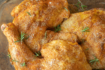 Marinated chicken tights with salt, black pepper, rosemary and paprika ready to be cooked