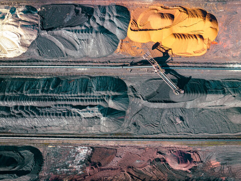 Industrial Site Aerial View. Sorting of Industrial Materials. Surface Mine Colored Minerals and Mining Heavy Equipment. Industrial Background.