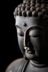 Stone buddha statue closeup with a black background created using generative AI tools