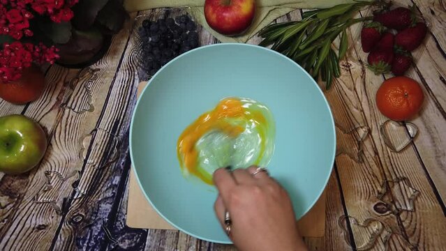 Female chef mixing eggs with whisker. Food preparation. High quality 4k footage