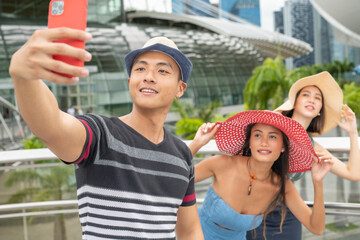 Three young asian friends explore the city enjoying life