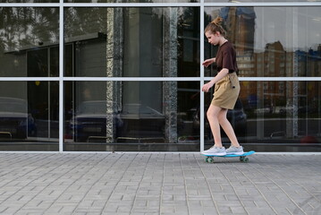 Teen girl skateboarding in the city