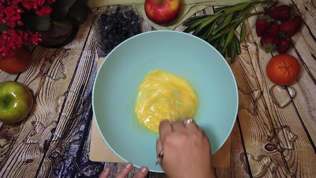 Making omlet or cake preparation. Overhead shot, cooking, food prep. High quality 4k footage