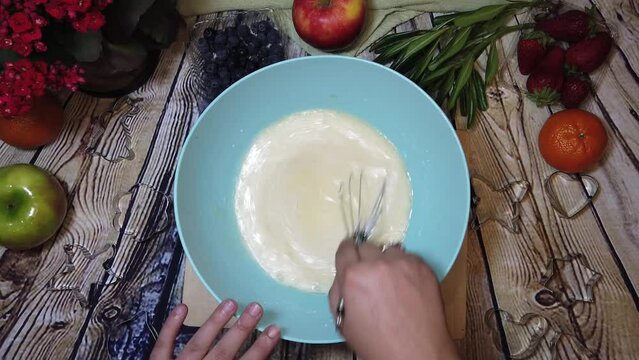 Making omlet or cake preparation. Overhead shot, cooking, food prep. High quality 4k footage