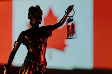 Lady Justice and Canada flag in the background.