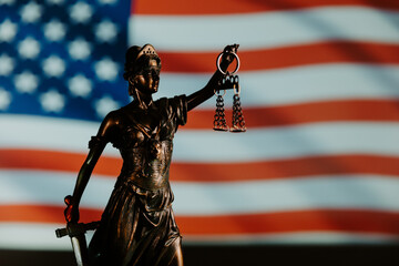 Lady Justice and flag of USA in the background. Law and court concept