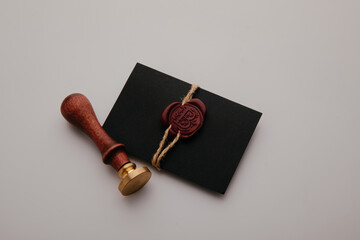 Notary public wax stamper. Black envelope with red wax seal and stamp