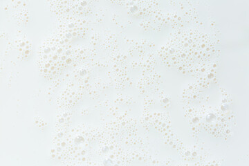 Fototapeta na wymiar macro milk background,White surface of milk and bubbles and ripples from above birds eye view