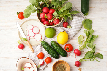 Radish and other spring vegetables on a wooden background, top view.