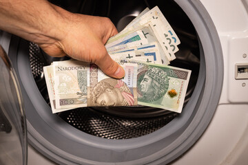 Polish money thrown into the washing machine, Concept, Money laundering, Illegal activity proceeds,...