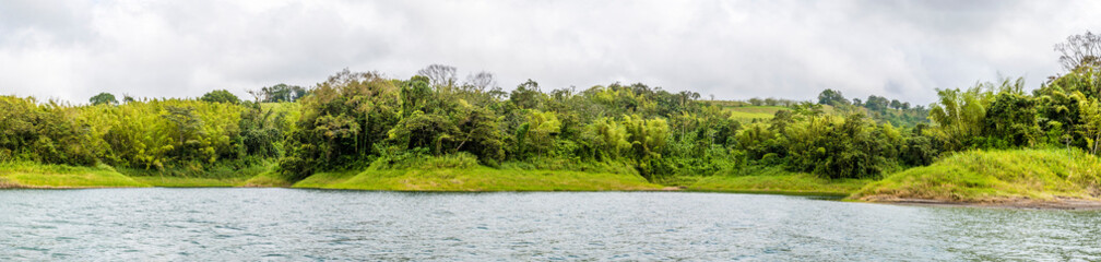 A panorama view towards inlets on the shoreline of the Arenal Lake in Costa Rica during the dry season