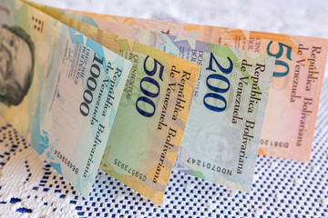 Venezuela money, Bolivares banknotes on white tablecloth at home, Household expenses and family budget concept