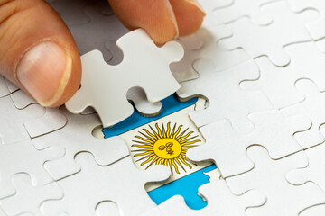 Argentina flag among white puzzle pieces