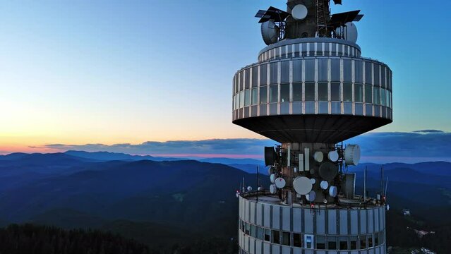 Tower Snezhana on peak of Snezhana covered with spruce forests in Rhodope mountains