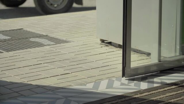 Automatic non-contact doors open and close. Close-up. Daylight sunlight