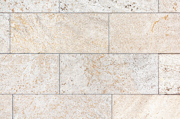 texture of a tiled beige stone wall as background, natural stone wall texture as background....