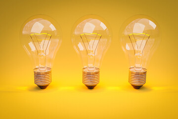three retro style lightbulbs with glowing filament standing in a row on infinite colorful yellow background; creativity design concept; 3D Illustration