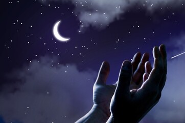 Fototapeta na wymiar Pray hands open to the blue night sky