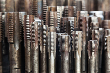 Multiple thread taps in different sizes, front view. Threading tool.