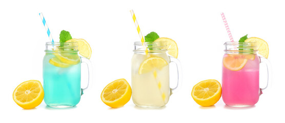 Cold, colorful summer lemonade drinks in mason jar glasses with lemons. Blueberry, lemon and strawberry in mason jar glasses isolated on a white background. - obrazy, fototapety, plakaty