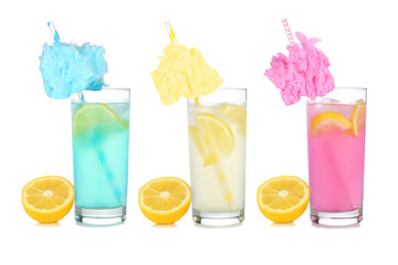 Cold, colorful cotton candy lemonade summer drinks. Three colors in tall glasses with lemons isolated on a white background.