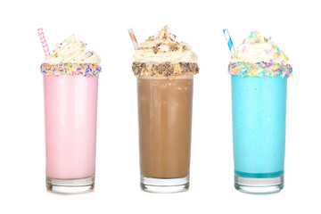 Fun colorful summer milkshakes with whipped cream isolated on a white background. Strawberry, chocolate and blueberry sweet drinks.