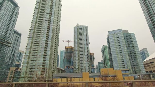 Wide car view of Toronto skyline at Gardiner Express way near Ontario lake. Toronto skyline right side front window view from car in highway at rainy gray winter