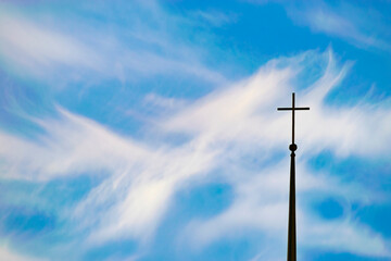 four-pointed cross of the Orthodox Church against a blue sky with clouds. daytime. close-up