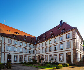Fototapeta premium Gorgeous old multistory building. Sunny day, beautiful architecture of the past.