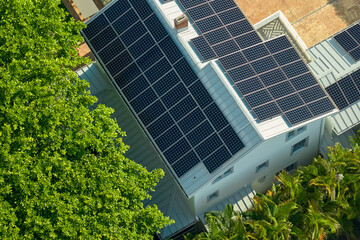 New residential house in USA with roof covered with solar panels for producing of clean ecological...