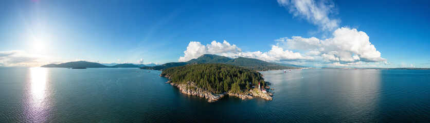 Lighthouse Park in West Vancouver, British Columbia, Canada. Aerial Panoramic Background. Sunny Cloudy Sky