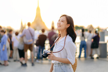 Portrait young beautiful asian woman smiling while travel at Wat Arun sunset view point, Bangkok,...