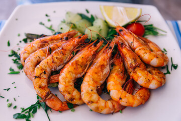 Grilled tiger shrimp with parsley sauce and lemon.