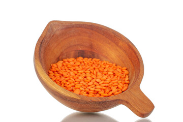 Red lentils with wooden cup, macro, isolated on white background.