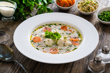 Fish soup on wooden table
