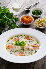 Fish soup on wooden table
