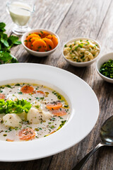 Fish soup on wooden table
