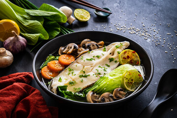 Fish soup on wooden table Asian style
